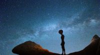 Illustration of an alien silhouetted against the Milky Way at night.