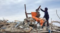 Child amidst rubble of a destroyed building.