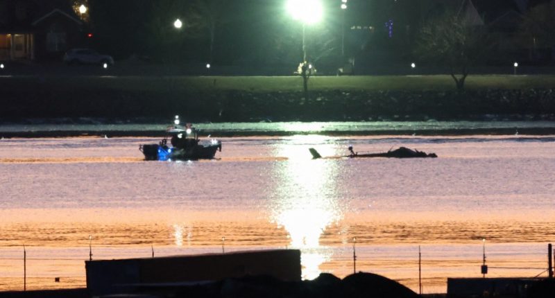 Rescue boat at helicopter crash site at sunrise.