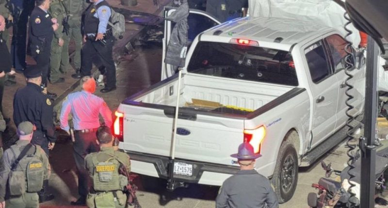 Police surround the white pick up truck used to run over dozens of people in New Orleans