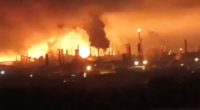 Oil refinery engulfed in flames.