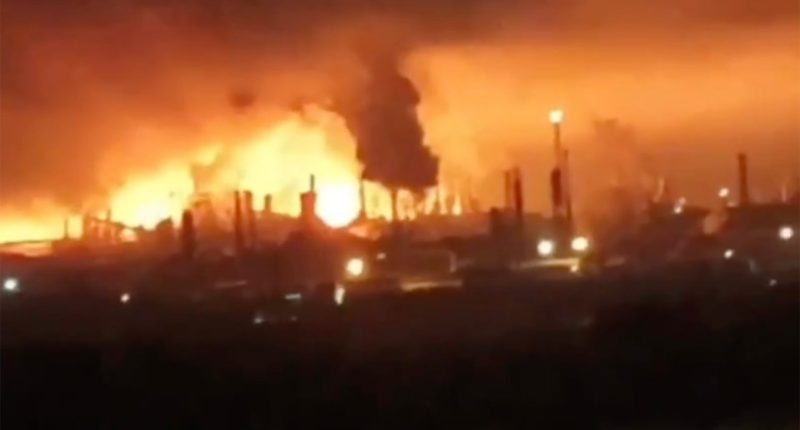Oil refinery engulfed in flames.