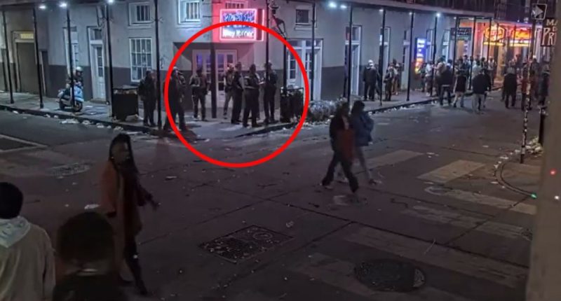 A group of cops stand on a corner in New Orleans