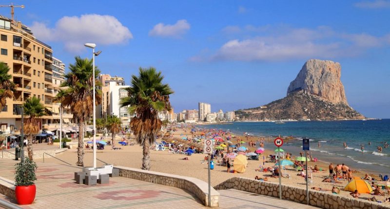 High-angle view of Benidorm's dense cityscape, hotels, and beach.