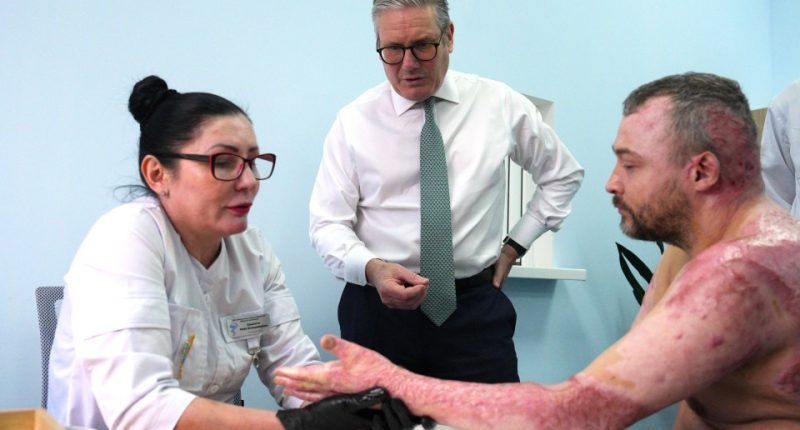 British Prime Minister Keir Starmer visits a Ukrainian soldier injured in a hospital in Kyiv.