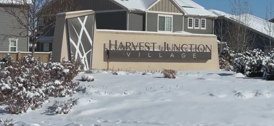 Snow-covered Harvest Junction Village sign.