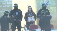 Released Israeli soldier holding certificate at Hamas event.