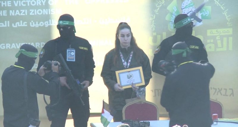Released Israeli soldier holding certificate at Hamas event.