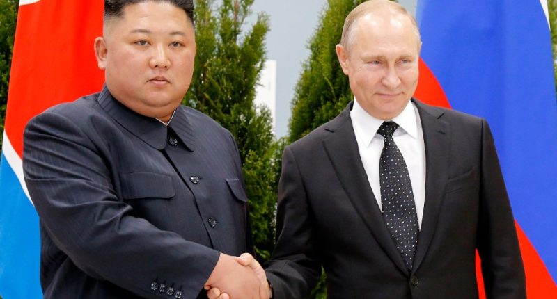 Kim Jong-un and Vladimir Putin shaking hands.