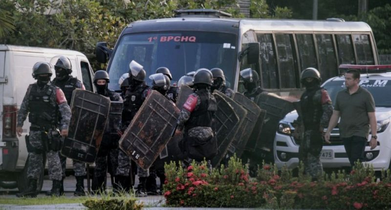 Riot police preparing to raid a Brazilian prison where at least 40 inmates were killed.