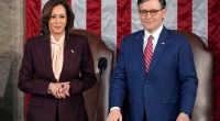 Vice President Kamala Harris stands with House Speaker Mike Johnson as a joint session of Congress convenes to confirm the Electoral College vote