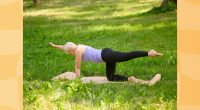 woman doing bird dog exercise on yoga mat in grassy area on summer day
