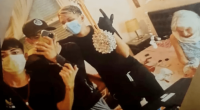 Photo of three masked teens taking a selfie with a distressed elderly woman tied to a bed.
