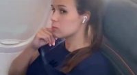 Video still of a woman on a plane refusing to switch seats with a crying child.