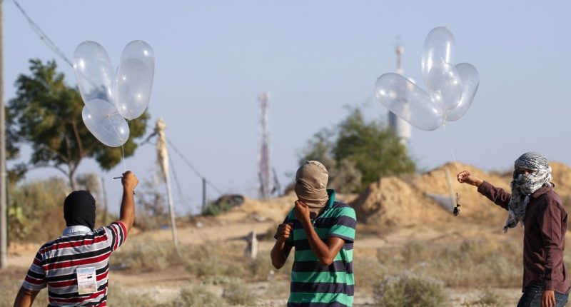 Palestinians preparing incendiary devices attached to condoms near the Gaza-Israel border.