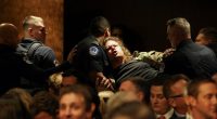 Security personnel removing a protester at Pete Hegseth's Senate confirmation hearing.