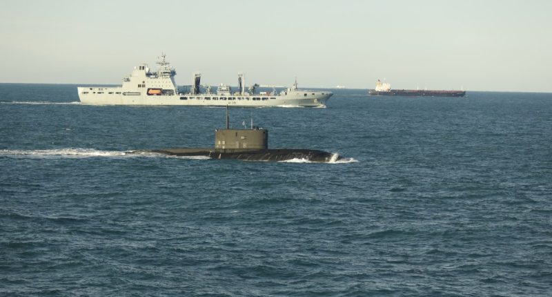 Submarine and ships at sea.