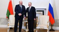Vladimir Putin and Alexander Lukashenko shaking hands.
