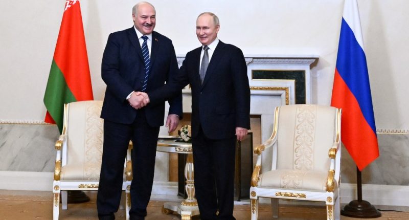 Vladimir Putin and Alexander Lukashenko shaking hands.