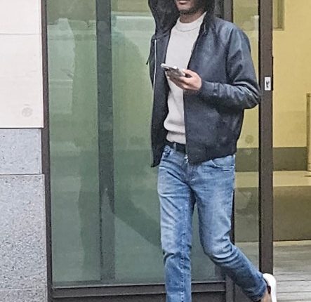 Abdulrahman Althani, Qatari Prince, walking and using a phone.