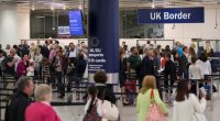 Passengers waiting in line at UK Border Control.