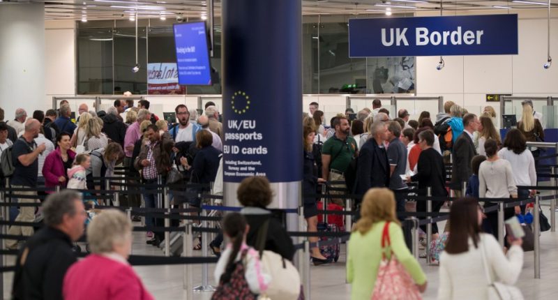 Passengers waiting in line at UK Border Control.