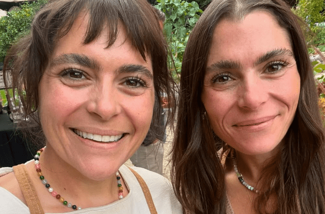Two women smiling for a selfie.