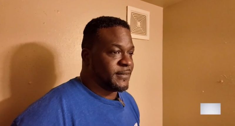 Man in blue shirt speaking.