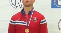 Vladimir Feshchenko, a Russian FSB counterintelligence officer, wearing a red jacket and gold medal.