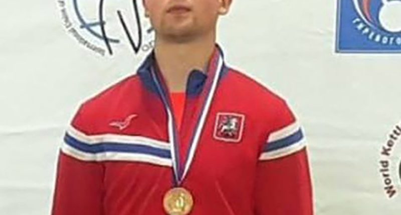 Vladimir Feshchenko, a Russian FSB counterintelligence officer, wearing a red jacket and gold medal.