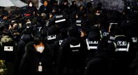 Police officers gathered near the residence of an impeached South Korean president.
