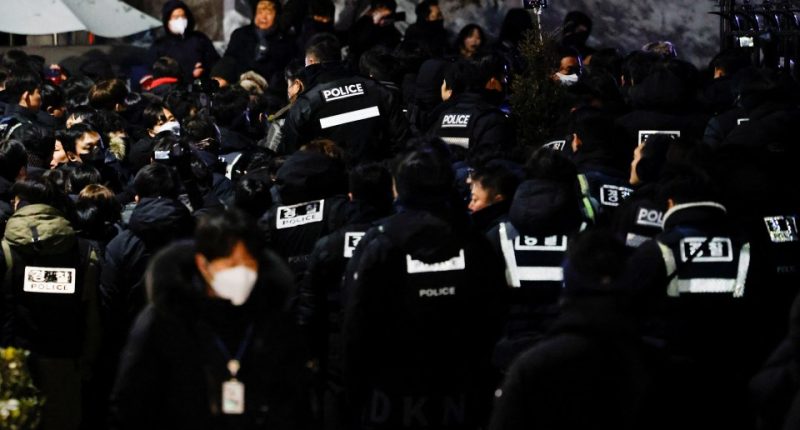 Police officers gathered near the residence of an impeached South Korean president.