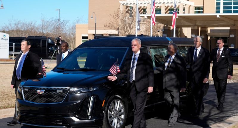 Jimmy Carter's personal bodyguards carried his flag-draped coffin through his hometown of Plains, Georgia