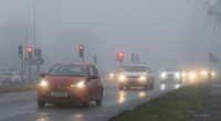 Cars driving in heavy fog.