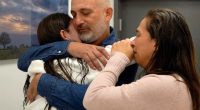 A family embraces after a hostage is released.