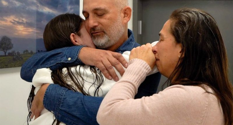 A family embraces after a hostage is released.
