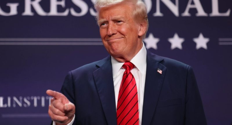 Donald Trump pointing at the camera at a Republican conference.