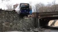 NYC MTA bus hangs precariously off overpass following collision