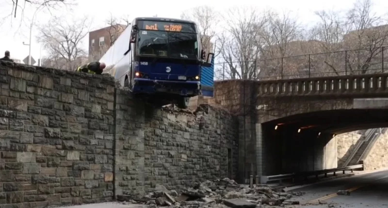 NYC MTA bus hangs precariously off overpass following collision