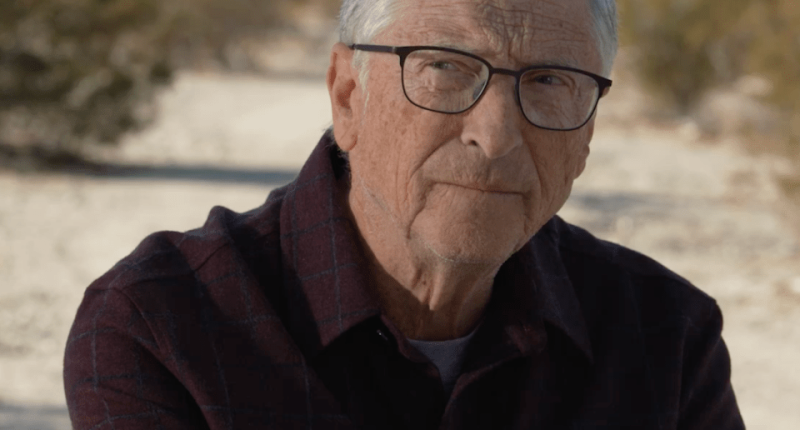 Portrait of an older man with gray hair and glasses.
