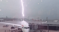 Lightning striking an airplane at an airport.