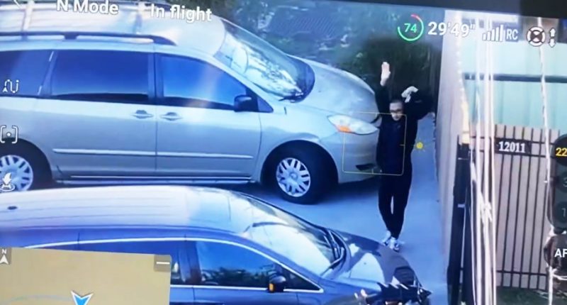 A man outside the New Orleans attack suspects Houston home with his hands up