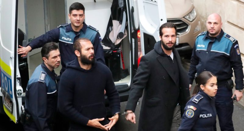 Andrew Tate and his brother Tristan Tate in handcuffs at a Bucharest court hearing.