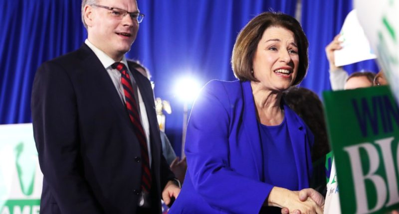 Amy Klobuchar shaking hands with John Bessler.