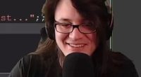 Streamer smiling while using a microphone.