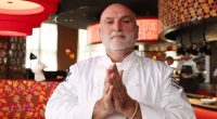 Portrait of José Andrés in his chef's jacket.
