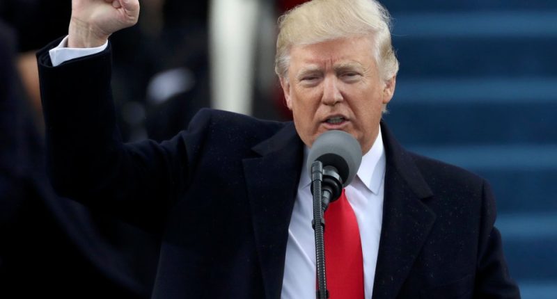 President Trump giving a speech with his fist raised.
