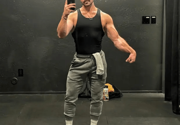 Man taking a selfie in gym attire.