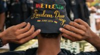 An attendee adjusts his Juneteenth-themed hat during a neighborhood Juneteenth festival on June 17, 2023 in Washington, DC.
