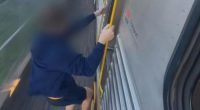 'Sickening' footage shows teenager hanging off the side of train